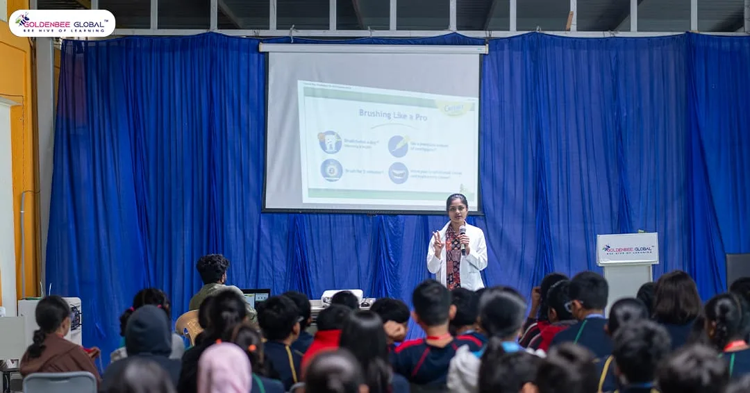 A dental health expert leading a Brushing Like a Pro session for GoldenBee students