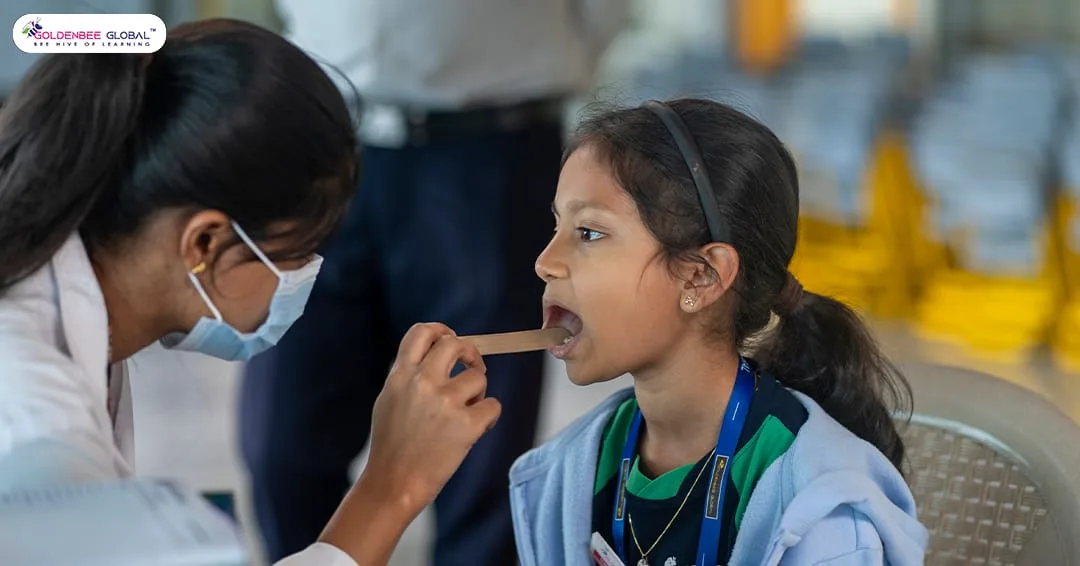 A GoldenBee student having an oral health screening at the dental camp
