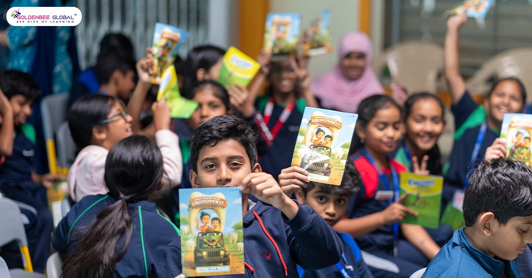 GoldenBee students holding oral-health awareness booklets at the camp
