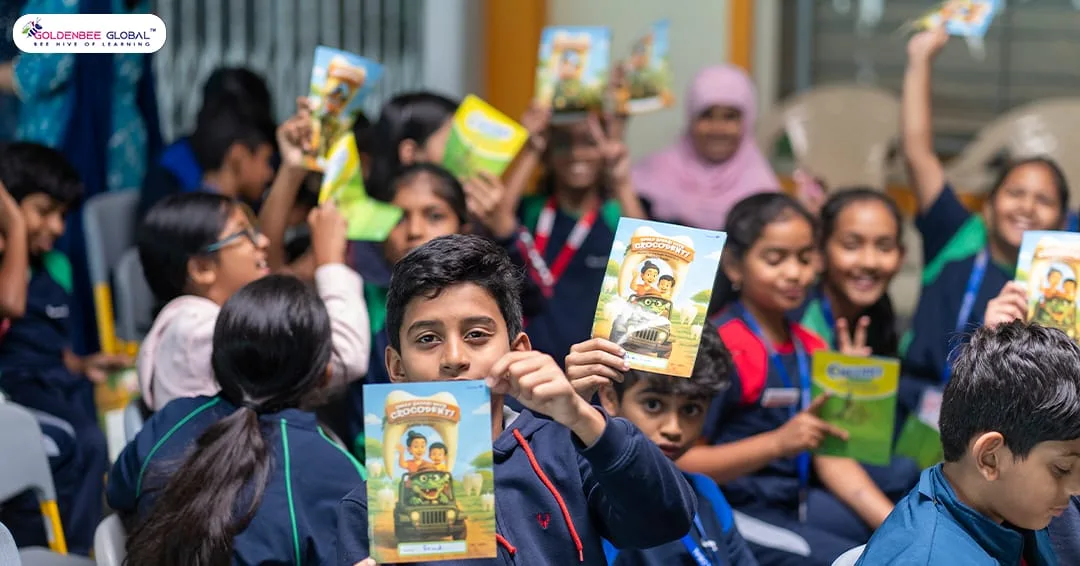 GoldenBee students holding oral-health awareness booklets at the camp