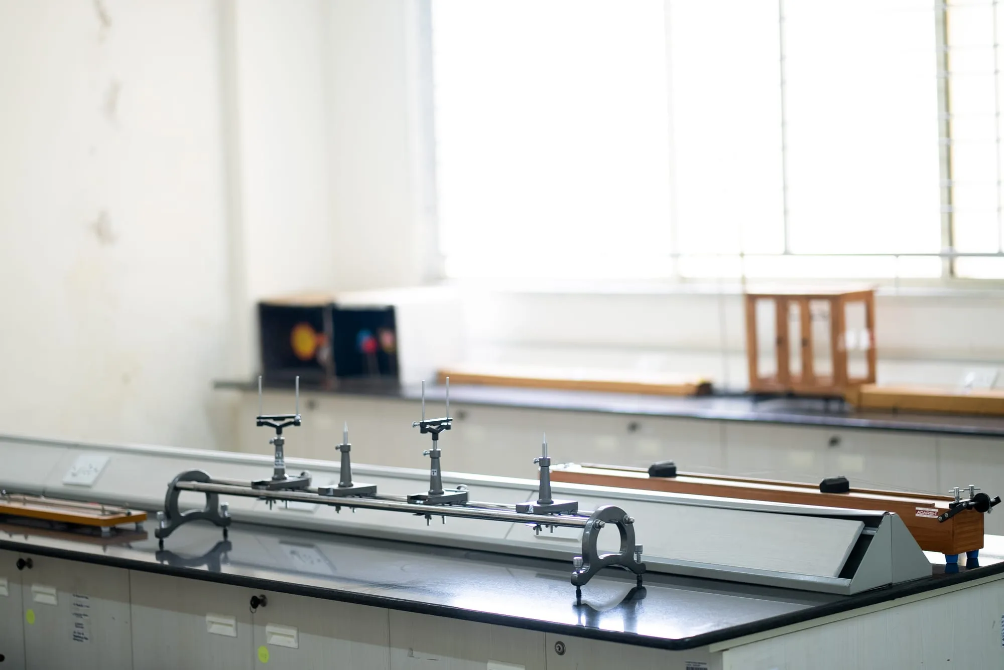 An optics bench and measuring apparatus laid out in a GoldenBee physics laboratory